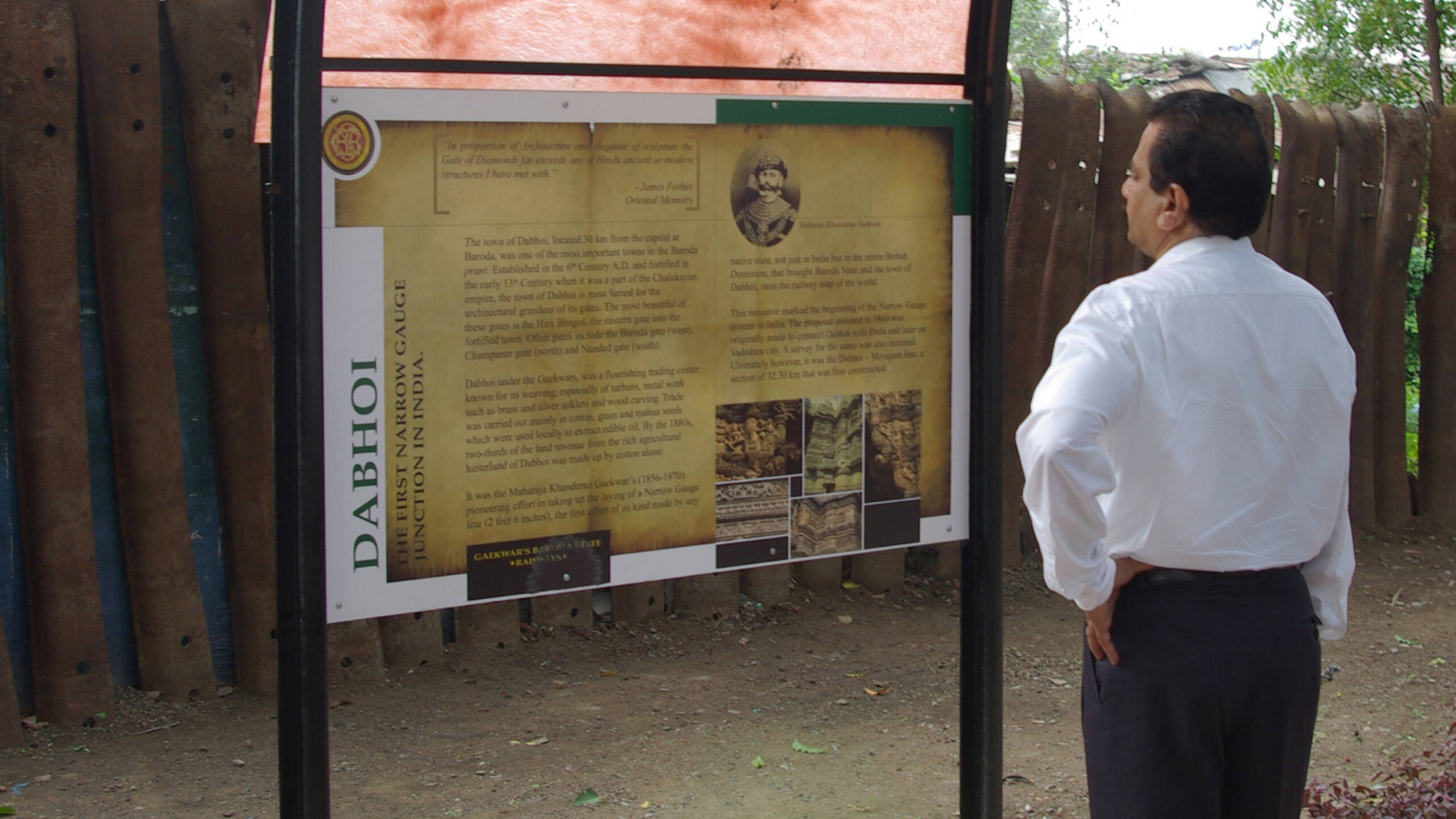 A Visitor reading Interpretation Panel at Railway Heritage Park, Dabhoi
