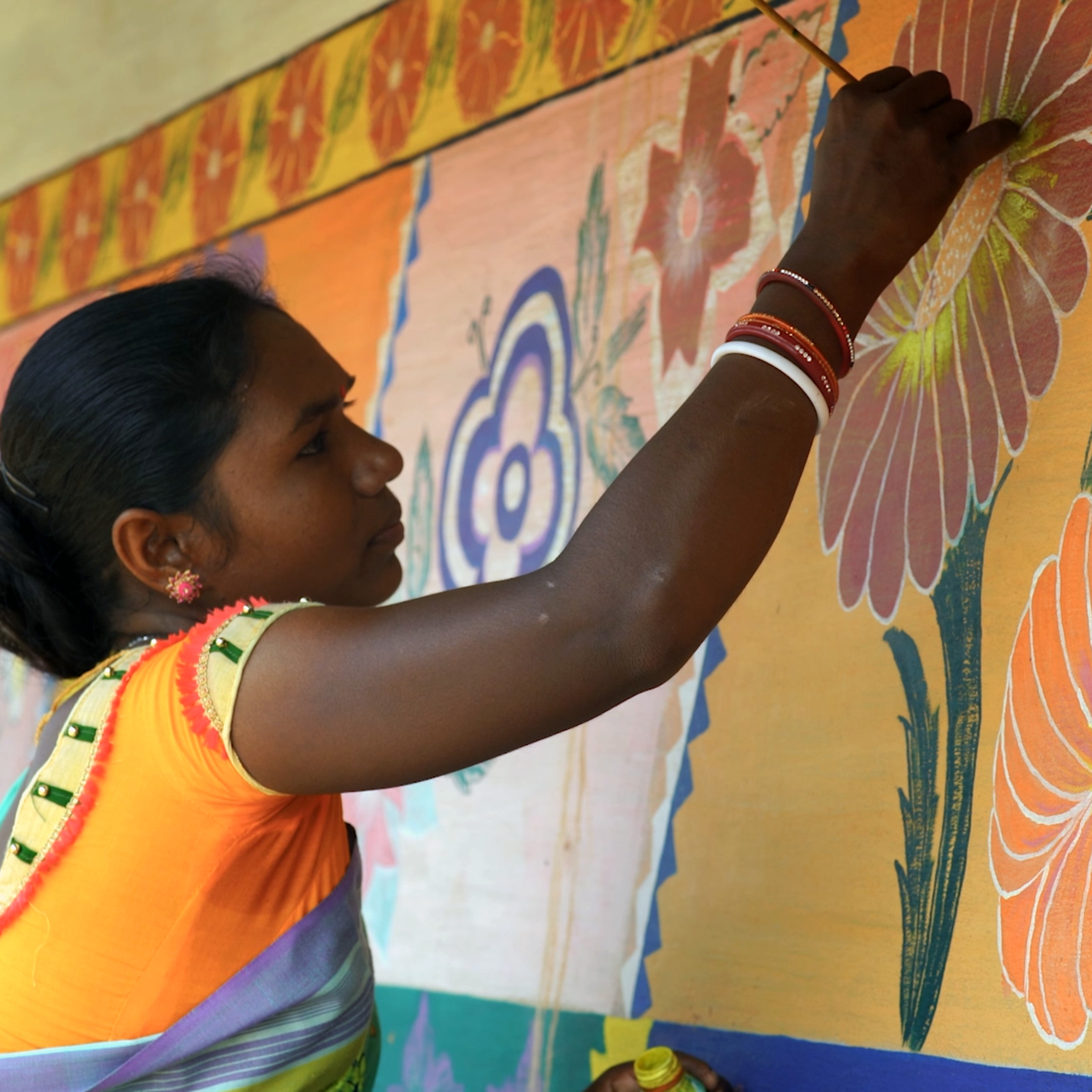 Santal women painting on wall