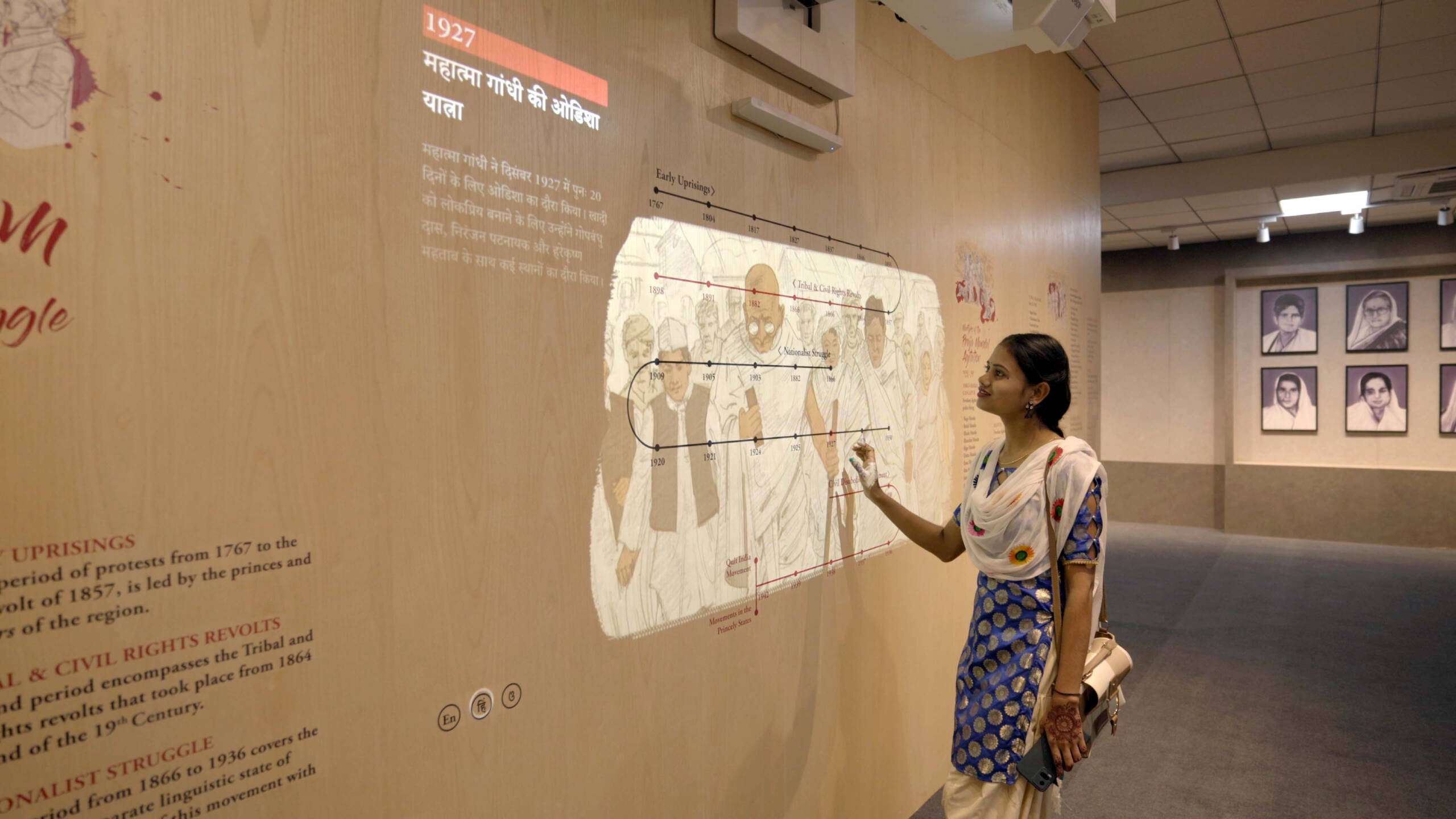A girl interacting with Sangram, an interactive timeline depicting the contribution of Odisha in the freedom struggle of India